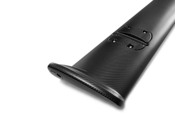 Mounting area of MUSE Dry Carbon Main Wing for Skyline GT-R BNR34, showing bolt pattern and carbon fiber surface detail.