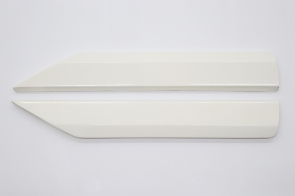 Unpainted rear bumper from VEILSIDE Aero Kit for FFZ400 RZ34, featuring mesh inserts and aggressive styling.