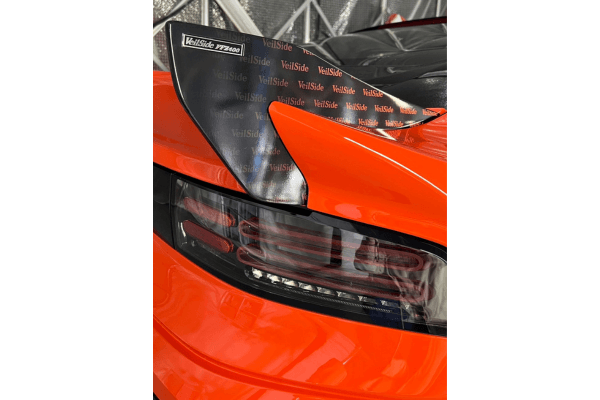 Close-up of rear taillight and VEILSIDE branded rear fender on FFZ400 RZ34, showcasing custom carbon fiber accents.