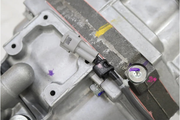 Close-up of TOYOTA R154 transmission casing for JZX100 Chaser Mark II, showing sensor connector and detailed housing texture.