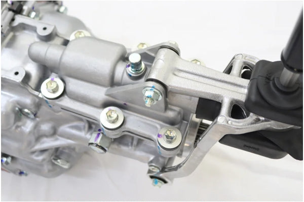 Top view of TOYOTA R154 transmission linkage and mounting bolts for JZX100 Chaser Mark II, highlighting mechanical components.