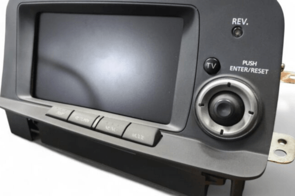 Front view of GRID RACING MFD Front Panel Finisher installed on Skyline BNR34 GTR, featuring joystick and TV/REV button layout.
