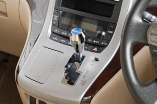GREDDY Shift Knob Option Adapter Screw M8 × P1.25 installed in a vehicle's center console for B-TYPE shift knob compatibility and height adjustment.