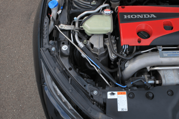 Engine bay of Civic Type R FK8 with FUJITSUBO EXH+ Hood Support installed, emphasizing lightweight titanium construction.