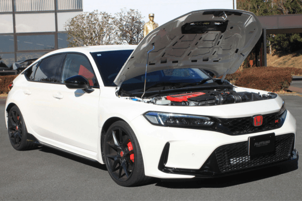 FUJITSUBO EXH+ Hood Support installed on a white Civic Type R FL5 with hood open, showcasing titanium burnt color gradation support rod.